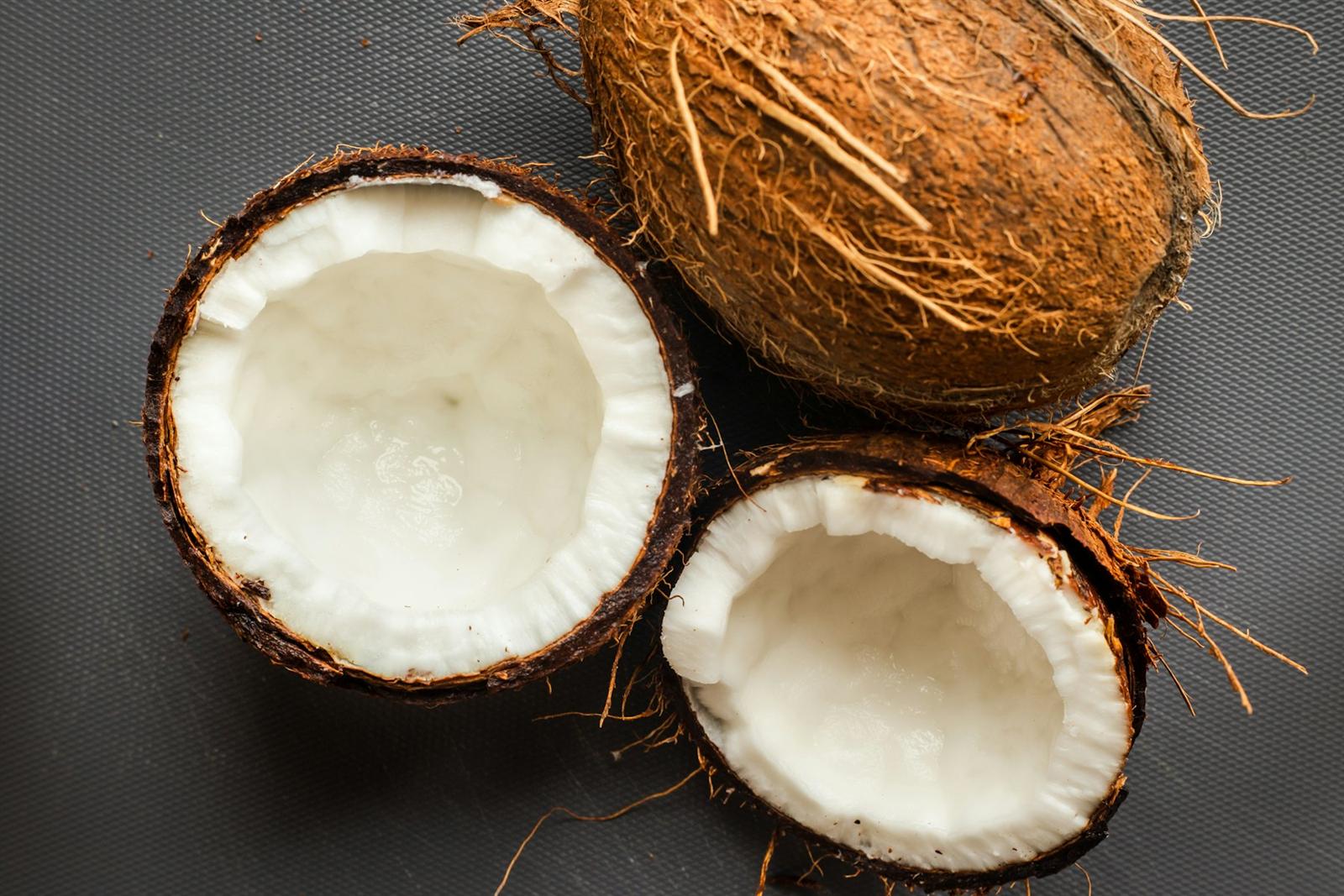 Halved husk coconuts showing white flesh